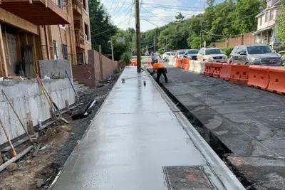 Sidewalk fresh pour street, sidewalk and curb work in New York